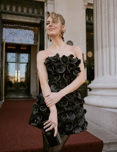 Actress Kara Tointon in a black dress at a red carpet event.